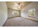 Large bedroom with ceiling fan, vaulted ceilings, and windows providing natural light at 5861 E Valley Hi Dr, Parker, CO 80138