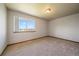 Bright bedroom features neutral walls, carpet, and natural light from a large window at 5861 E Valley Hi Dr, Parker, CO 80138