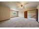Bedroom with vaulted ceiling, ceiling fan, large window, and an open door at 5861 E Valley Hi Dr, Parker, CO 80138