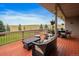 Inviting covered deck with ample seating offering scenic views and a relaxing outdoor living space at 5861 E Valley Hi Dr, Parker, CO 80138