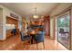 Bright dining area with wood floors, a round table, and a sliding glass door to the deck at 5861 E Valley Hi Dr, Parker, CO 80138