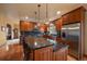 Elegant kitchen with wood cabinets, a granite island, and stainless steel appliances at 5861 E Valley Hi Dr, Parker, CO 80138