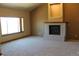 Cozy living room with a brick fireplace, neutral carpeting, and large windows for natural light at 5861 E Valley Hi Dr, Parker, CO 80138