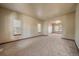 Expansive living room with neutral carpeting, ample natural light, and an open layout at 5861 E Valley Hi Dr, Parker, CO 80138