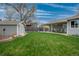 Expansive backyard with a manicured lawn, storage shed, and covered patio for outdoor living at 7472 Jay Ct, Arvada, CO 80003