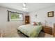 Comfortable bedroom with a large window, ceiling fan, and neutral decor at 7472 Jay Ct, Arvada, CO 80003