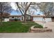 Charming home featuring a well-maintained lawn, mature trees, and a welcoming entrance at 7472 Jay Ct, Arvada, CO 80003