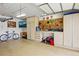 Organized garage with ample storage, workbench, and epoxy flooring at 7472 Jay Ct, Arvada, CO 80003