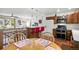 Open-concept kitchen with stainless steel appliances, breakfast bar, and dining area at 7472 Jay Ct, Arvada, CO 80003