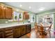 Eat-in kitchen featuring wood cabinets, a window over the sink, and sliding glass doors to the backyard at 7472 Jay Ct, Arvada, CO 80003