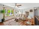 Cozy living room with a bay window, wood floors, a leather sofa, and decorative rug at 7472 Jay Ct, Arvada, CO 80003