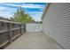 Fenced side yard with a concrete walkway and a white privacy gate at 7472 Jay Ct, Arvada, CO 80003