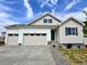 Charming home featuring a three-car garage, modern siding, and a well-maintained yard at 229 Wooten Ave, Brighton, CO 80601
