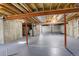 Unfinished basement featuring high ceilings and exposed beams, ready to be customized at 4270 Defoe St, Strasburg, CO 80136