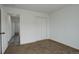 Bright bedroom featuring neutral carpet, a closet, and fresh white paint at 4270 Defoe St, Strasburg, CO 80136