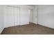 Neutral bedroom with a walk-in closet and doorway to a connecting room at 4270 Defoe St, Strasburg, CO 80136