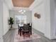 Cozy dining room featuring modern lighting, a dark wood table, and neutral decor at 4270 Defoe St, Strasburg, CO 80136