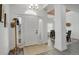 Bright foyer featuring a white door with sidelights, wood floors, and hat rack at 4270 Defoe St, Strasburg, CO 80136