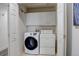 A convenient laundry room with modern washer, dryer and overhead cabinets at 4270 Defoe St, Strasburg, CO 80136