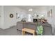 Bright living room with fireplace and gray L-shaped couch at 4270 Defoe St, Strasburg, CO 80136
