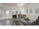 Inviting living room featuring a fireplace, neutral walls, and stylish decor at 4270 Defoe St, Strasburg, CO 80136