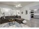 Open-concept living room with modern decor, gray sofa, and hardwood floors at 4270 Defoe St, Strasburg, CO 80136