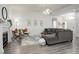 Spacious living room with a fireplace, comfortable seating, and hardwood floors at 4270 Defoe St, Strasburg, CO 80136