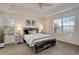 Comfortable main bedroom with a rustic wood bed frame, white walls, and views from two windows at 4270 Defoe St, Strasburg, CO 80136