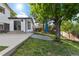 Backyard features mature trees, patio, lawn, and white house at 5831 W 108Th Pl, Westminster, CO 80020