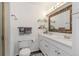 Well-lit bathroom featuring a double vanity with stylish fixtures and a framed mirror at 5831 W 108Th Pl, Westminster, CO 80020