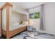 Charming bedroom features a canopy bed, stylish rug, and window with lots of light at 5831 W 108Th Pl, Westminster, CO 80020