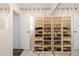 Organized walk-in closet with clear storage boxes and mirrored doors for extra light at 5831 W 108Th Pl, Westminster, CO 80020