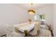 Elegant dining room featuring a sleek white table, upholstered chairs, and modern chandelier at 5831 W 108Th Pl, Westminster, CO 80020