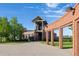 Brick fitness center with modern architectural details, a brick-paved entrance, and manicured lawn at 5831 W 108Th Pl, Westminster, CO 80020