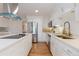 Modern kitchen with white cabinets, stainless appliances, and a breakfast bar at 5831 W 108Th Pl, Westminster, CO 80020