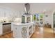 Bright kitchen with white cabinets, stainless steel appliances, and a center island with storage at 5831 W 108Th Pl, Westminster, CO 80020