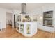 Well-lit kitchen with white cabinetry, stainless steel appliances, and a center island at 5831 W 108Th Pl, Westminster, CO 80020