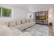 Cozy living room with a large sectional couch, built-in shelving, and a decorative rug at 5831 W 108Th Pl, Westminster, CO 80020