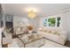 Bright living room featuring a large window, modern decor, and a glamorous chandelier at 5831 W 108Th Pl, Westminster, CO 80020
