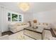 Cozy living room with large window, plush sofas, and a chic mirrored coffee table at 5831 W 108Th Pl, Westminster, CO 80020