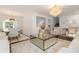 Open-concept living and dining area with modern furnishings, a chandelier, and stylish decor at 5831 W 108Th Pl, Westminster, CO 80020