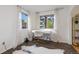 Bright office space with hardwood floors, two windows, and a sleek modern desk at 5831 W 108Th Pl, Westminster, CO 80020