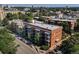 Birds eye view of an urban apartment building featuring trees, balconies, and ample street parking at 1376 N Pearl St # B1, Denver, CO 80203