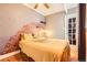 Inviting bedroom with unique brick accent wall, hardwood floors, and a glass door leading to the hallway at 1376 N Pearl St # B1, Denver, CO 80203