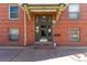 Close up of apartment building entrance with glass door, the address, and brick facade at 1376 N Pearl St # B1, Denver, CO 80203