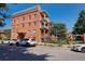 Charming brick apartment building with manicured landscaping, balconies, and street parking at 1376 N Pearl St # B1, Denver, CO 80203
