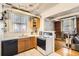 Efficient kitchen with modern appliances, wooden cabinets, and a view to the cozy living space at 1376 N Pearl St # B1, Denver, CO 80203