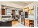 A bright kitchen featuring stainless steel appliances and a view into the adjacent living space at 1376 N Pearl St # B1, Denver, CO 80203