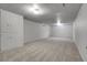 Spacious basement area featuring neutral carpet, bright lighting, and storage cabinets at 375 Kohl St, Broomfield, CO 80020