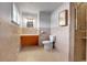 Well-lit bathroom with tiled walls and floors, a vanity, toilet, and glass-enclosed shower at 375 Kohl St, Broomfield, CO 80020